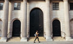 Lady walking passed a bank that has refused to help her. Talk to our mortgage advisers at ME Financial Services